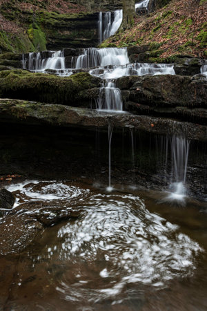 Beautiful peaceful landscape image of Scaleber Force waterfall in Yorkshire Dales in England during Winter morningの写真素材