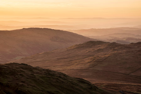 Lovely Winter landscape view from Red Screeds across misty layers of mountains Ill Bell, Stony Cove Pike and Tarn Cragの写真素材