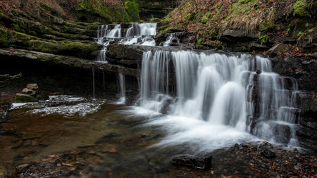 Beautiful peaceful landscape image of Scaleber Force waterfall in Yorkshire Dales in England during Winter morningの写真素材