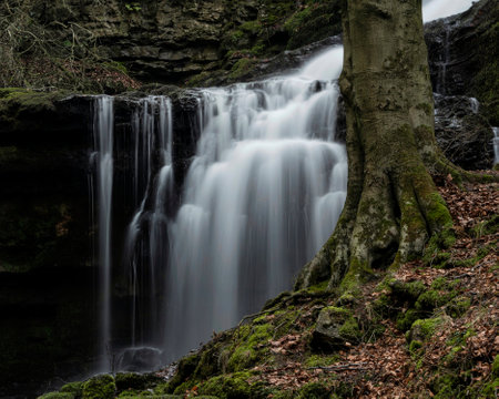 Beautiful dramatic landscape image of Scaleber Force waterfall in Yorkshire Dales in England during Winter morningの写真素材