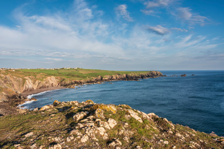 Stunning sunrise and sunset landscape image of popular tourist l;ocation at Kynance Cove in Cornwall England with colourful skyの写真素材