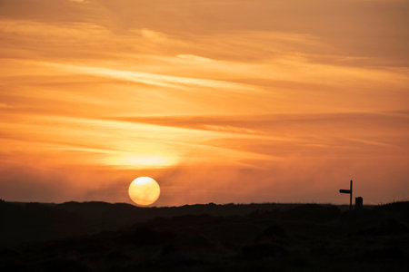 Stunning sunrise and sunset landscape image of popular tourist l;ocation at Kynance Cove in Cornwall England with colourful skyの写真素材