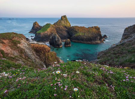 Stunning sunrise and sunset landscape image of popular tourist l;ocation at Kynance Cove in Cornwall England with colourful skyの写真素材