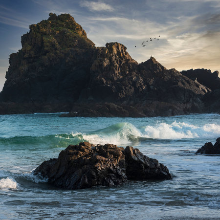 Stunning sunrise and sunset landscape image of popular tourist l;ocation at Kynance Cove in Cornwall England with colourful skyの写真素材