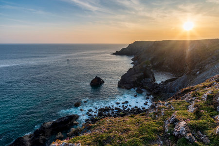 Stunning sunrise and sunset landscape image of popular tourist l;ocation at Kynance Cove in Cornwall England with colourful skyの写真素材