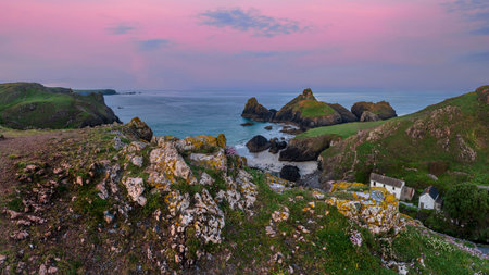 Stunning sunrise and sunset landscape image of popular tourist l;ocation at Kynance Cove in Cornwall England with colourful skyの写真素材