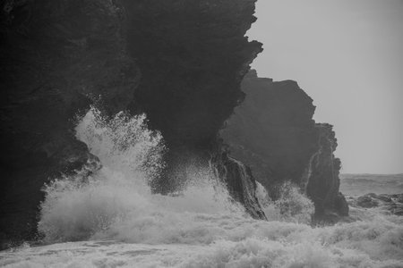 Crashing waves on beach at Church Cove in Cornwall UK landscape image of stormy Summer weatherの写真素材
