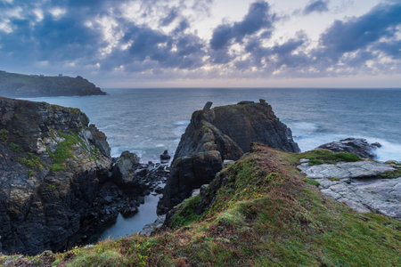 Beautiful dramatic Summer sunrise over Lizard Point in Cornwall UK with lovely glowing sky and cloudsの写真素材
