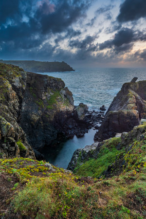 Beautiful dramatic Summer sunrise over Lizard Point in Cornwall UK with lovely glowing sky and cloudsの写真素材