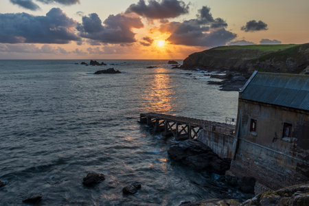 Beautiful Summer sunset landscape image of Lizard Point in Cornwall UK during colourful duskの写真素材