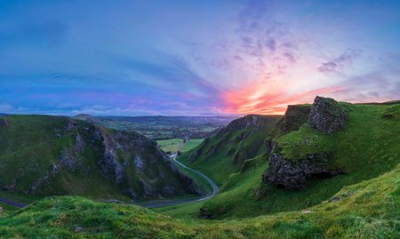 Stunning early Autumn sunrise landscape image viewed along Winnats Pass in Peak District Englandの写真素材