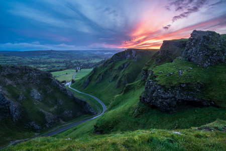 Stunning early Autumn sunrise landscape image viewed along Winnats Pass in Peak District Englandの写真素材