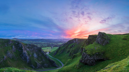 Stunning early Autumn sunrise landscape image viewed along Winnats Pass in Peak District Englandの写真素材