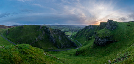 Stunning early Autumn sunrise landscape image viewed along Winnats Pass in Peak District Englandの写真素材