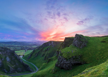 Stunning early Autumn sunrise landscape image viewed along Winnats Pass in Peak District Englandの写真素材