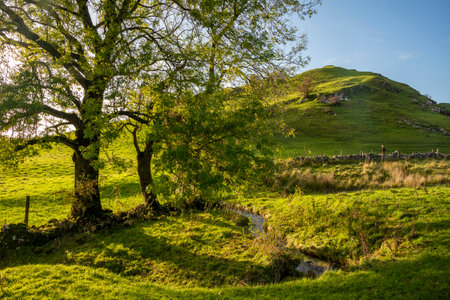 Beautiful landscape image of view along country lanes towards Chrome Hil in Peak District Nationa lPark in Englandの写真素材