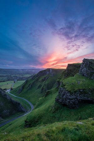 Stunning early Autumn sunrise landscape image viewed along Winnats Pass in Peak District Englandの写真素材