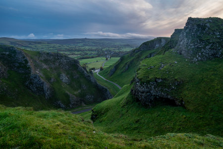 Stunning early Autumn sunrise landscape image viewed along Winnats Pass in Peak District Englandの写真素材