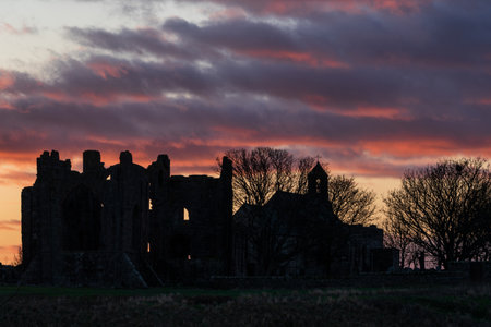 Stunning landscape image of Lindisfarne, Holy Island in Northumberland England during moody Winter dayの写真素材