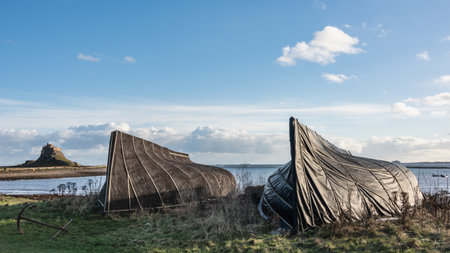 Stunning landscape image of Lindisfarne, Holy Island in Northumberland England during moody Winter dayの写真素材