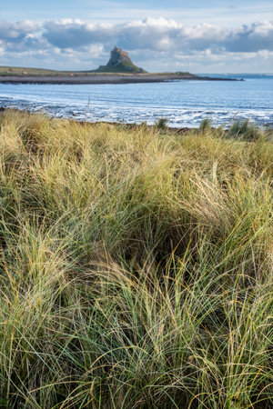 Stunning landscape image of Lindisfarne, Holy Island in Northumberland England during moody Winter dayの写真素材
