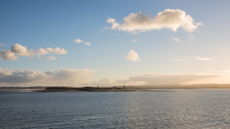 Stunning landscape image of Lindisfarne, Holy Island in Northumberland England during moody Winter dayの写真素材