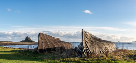 Stunning landscape image of Lindisfarne, Holy Island in Northumberland England during moody Winter dayの写真素材