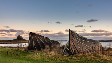 Stunning landscape image of Lindisfarne, Holy Island in Northumberland England during moody Winter dayの写真素材