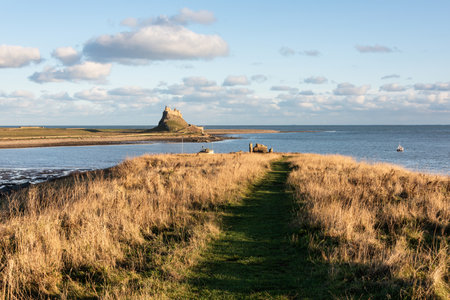 Stunning landscape image of Lindisfarne, Holy Island in Northumberland England during moody Winter dayの写真素材