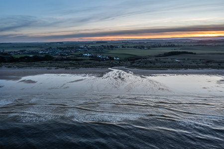 Beautiful aerial drone landscape image of Northumberland beach in Northern England during Winter sunriseの写真素材
