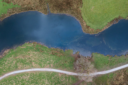 Beautiful aerial drone landscape image over River Brathay near Elterwater in Lake District with Langdale Pikes in distanceの写真素材
