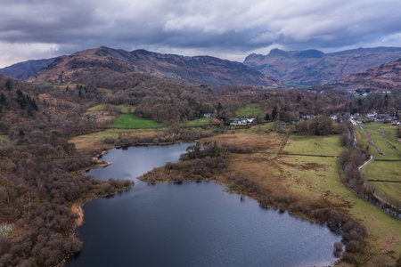 Beautiful aerial drone landscape image over River Brathay near Elterwater in Lake District with Langdale Pikes in distanceの写真素材