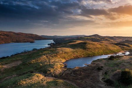 Beautiful Spring sunset landscape aerial drone image in Lake District looking towards Old Man of Conistonの写真素材