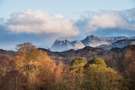 Stunning Spring landscape image in Lake District looking towards Langdale Pikes during colorful sunsetの写真素材