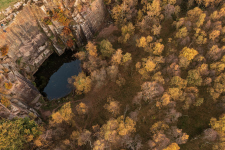 Beautiful aerial drone landscape image of Autumn Fall forest in misty morning in Peak District during peak colourの写真素材