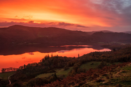 Stunning and atmospheric pre-dawn Autumn landscape of Derwentwater viewed from Catbells mountainの写真素材