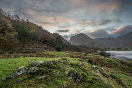 Beautiful Autumn sunrise landscape image of Buttermere in Lake Districtの写真素材