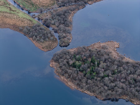 Beautiful aerial drone landscape imsge of Loughrigg Tarn in Autumn in Lake Districtの写真素材