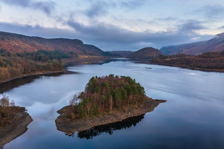 Beautiful aerial drone landscape image of Thirlmere in Lake District during lovely Autumn Fall sunriseの写真素材