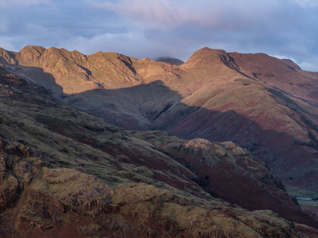 Stunning aerial drone landscape image of Blea Tarn and Langdale Valley in Lake District during vibrant Autumn sunriseの写真素材