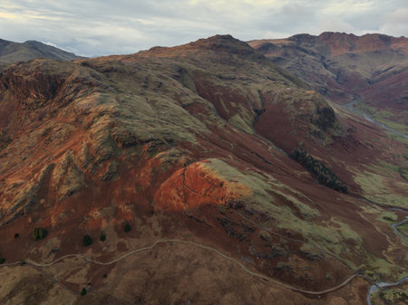 Stunning aerial drone landscape image of Blea Tarn and Langdale Valley in Lake District during vibrant Autumn sunriseの写真素材