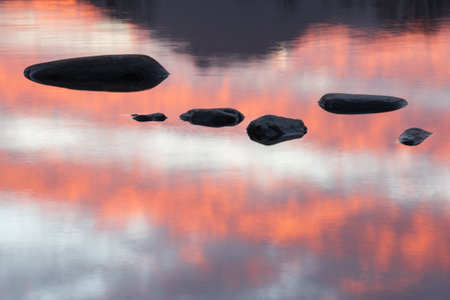 Sunset landscape of Derwentwater in Lake District during Autumn with dramatic pink sky and reflections in lakeの写真素材