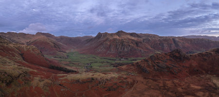 Stunning aerial drone landscape image of Blea Tarn and Langdale Valley in Lake District during vibrant Autumn sunriseの写真素材