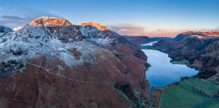 Stunning aerial drone landscape in Autumn Winter of snowcapped mountains around Buttermere in Lake District at sunriseの写真素材