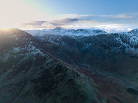 Stunning aerial drone landscape in Autumn Winter of snowcapped mountains around Buttermere in Lake District at sunriseの写真素材