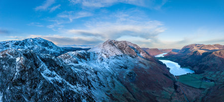 Stunning aerial drone landscape in Autumn Winter of snowcapped mountains around Buttermere in Lake District at sunriseの写真素材