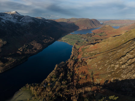 Stunning aerial drone landscape in Autumn Winter of snowcapped mountains around Buttermere in Lake District at sunriseの写真素材