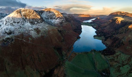 Stunning aerial drone landscape in Autumn Winter of snowcapped mountains around Buttermere in Lake District at sunriseの写真素材