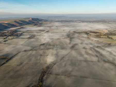 Beautiful aerial drone landscape sunrise image of atmospheric cloud inversion over South Downs escarpmentの写真素材