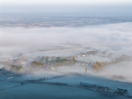 Beautiful aerial drone landscape sunrise image of atmospheric cloud inversion over South Downs escarpmentの写真素材